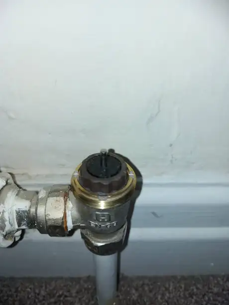 A radiator valve and its pipe at skirting level
