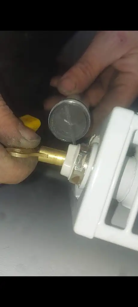 A pressure gauge being read at a radiator