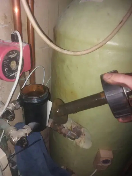 A hot water cylinder with pump and filter fitted alongside