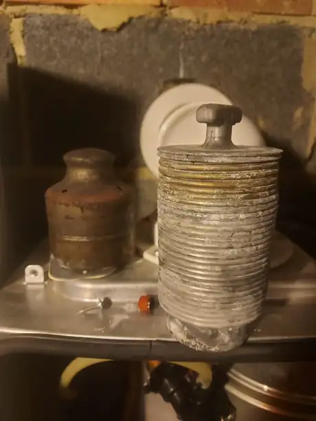 A heavily scaled boiler component stood on a work surface