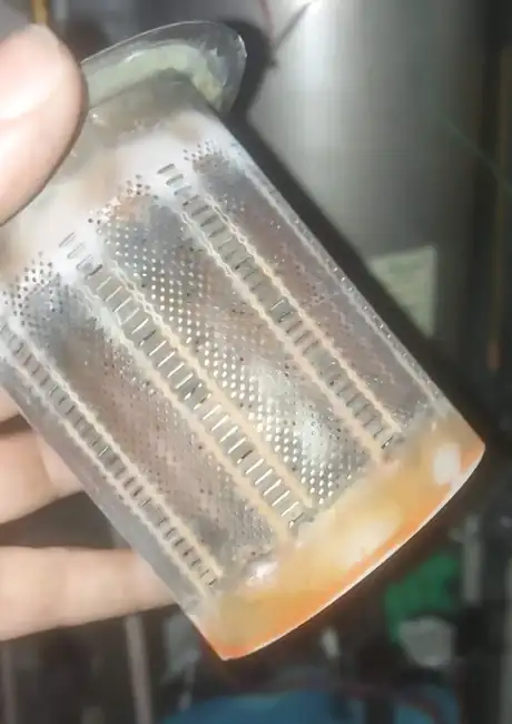 A plate heat exchanger held up, furred with limescale