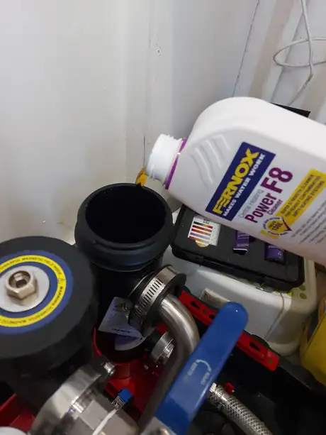 Flushing chemicals and a power flush unit set out ready