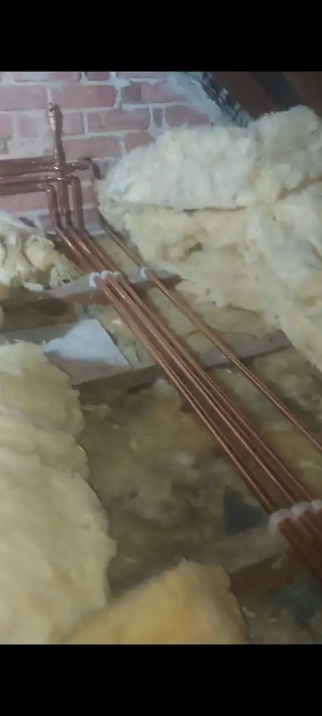 Pipework run through loft insulation