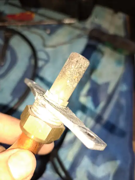 A corroded fitting held in the hand