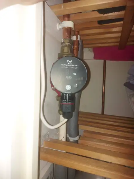 A Grundfos circulating pump in an airing cupboard