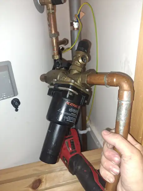 A system filter being fitted to copper pipework