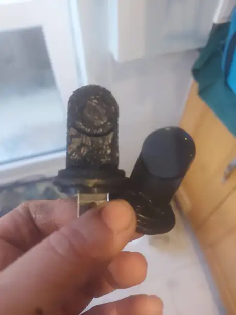 A sooted electrode held in the hand
