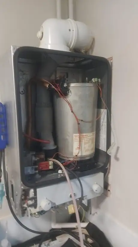 The inside of an old boiler, dirty and unserviced