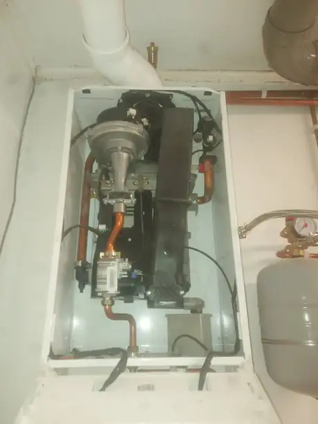 The gas valve and burner inside a clean boiler