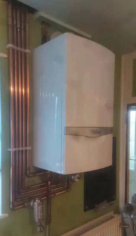 A Vaillant boiler with copper pipework run down the wall