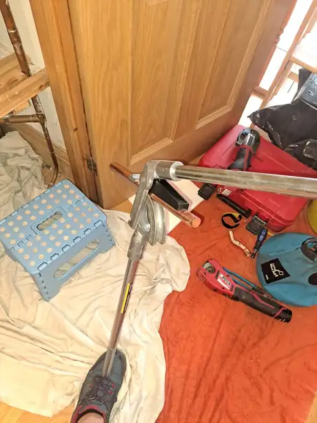 A hallway with dust sheets down and tools set out during a job