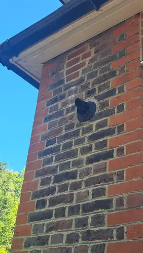 A flue terminal checked on the outside wall of a property