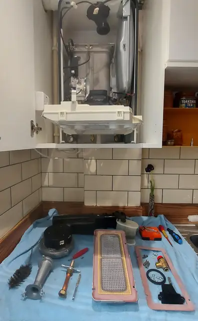Filter, gaskets and tools laid out ready before a boiler service starts