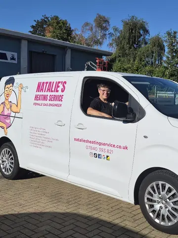 Natalie at the wheel of her van, signwritten with Natalie's Heating Service and female gas engineer